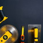 Hand tools arranged on a black surface, featuring saws, levels — Vavada vavada000com