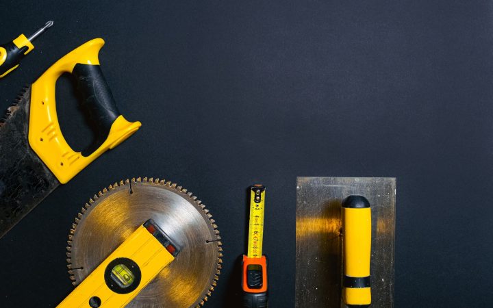 Hand tools arranged on a black surface, featuring saws, levels — Vavada vavada000com